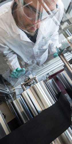 NREL-researcher-Scott-Mauger-coats-a-fuel-cell-catalyst-layer-onto-carbon-paper-diffusion-media-251x500-1 Man looking at canisters